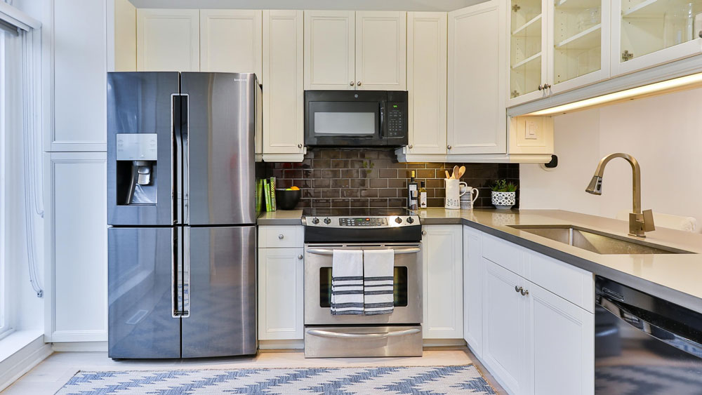 A kitchen with a french door refrigerator