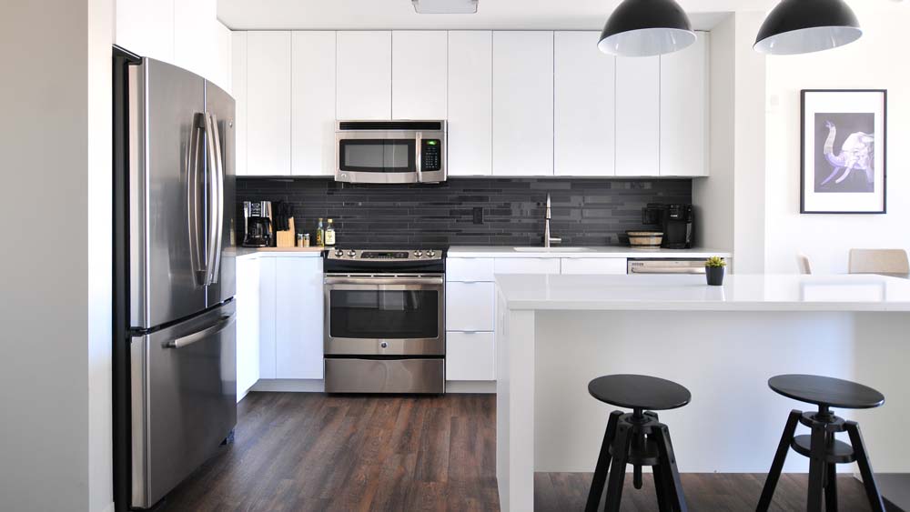 A bright, modern kitchen with white cabinets