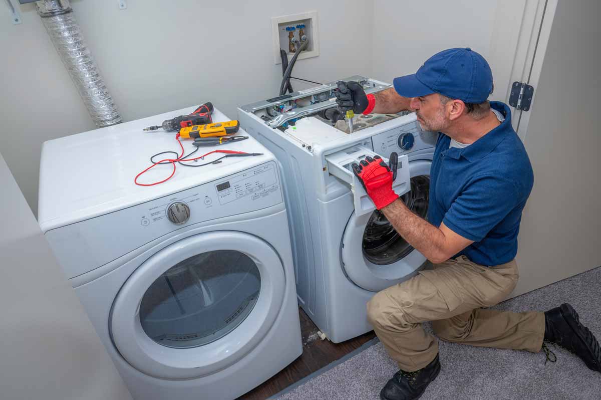 Appliance repair technician working on a washing machine