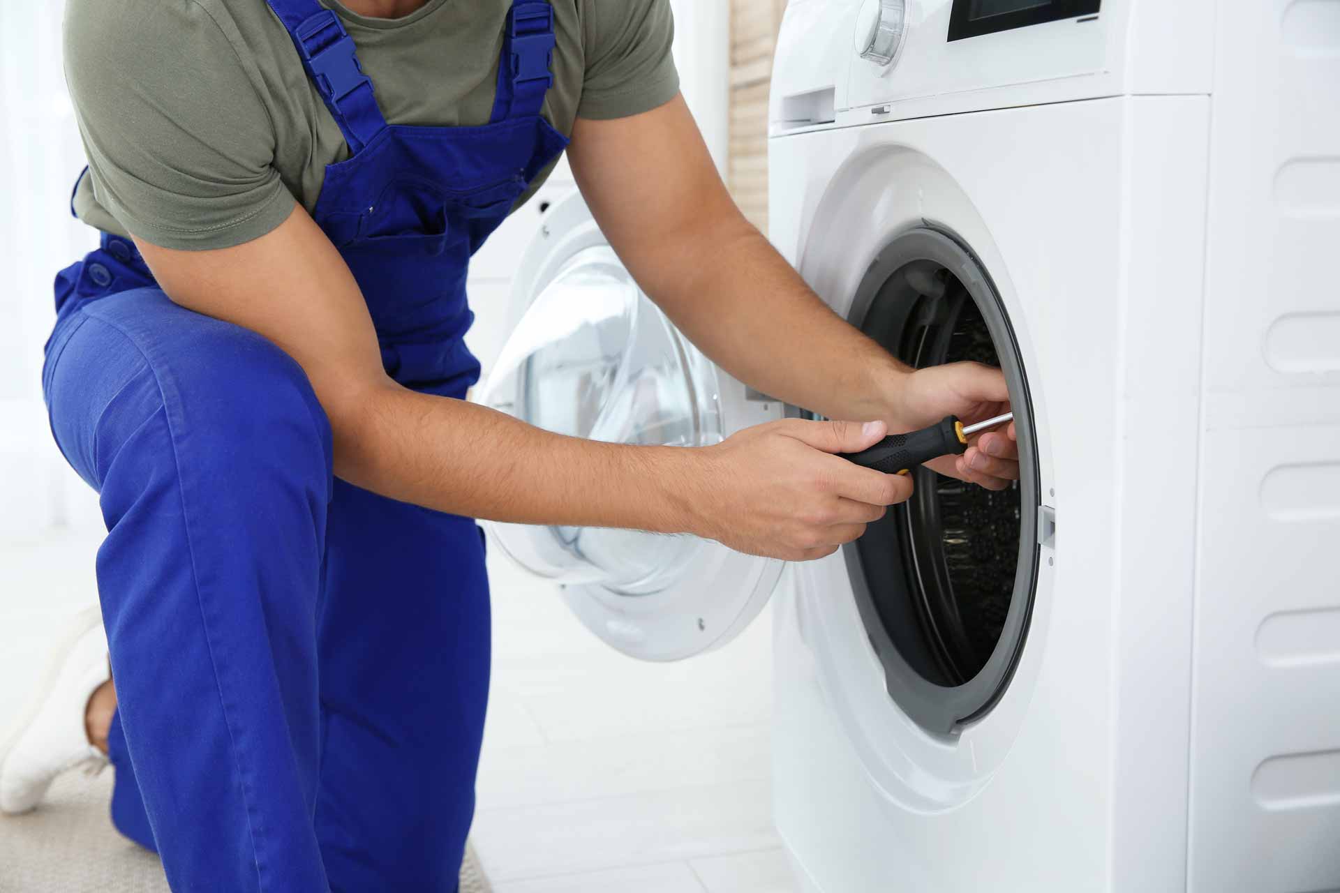 Appliance repair technician working on a clothes dryer